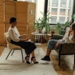 woman in white shirt sitting on chair