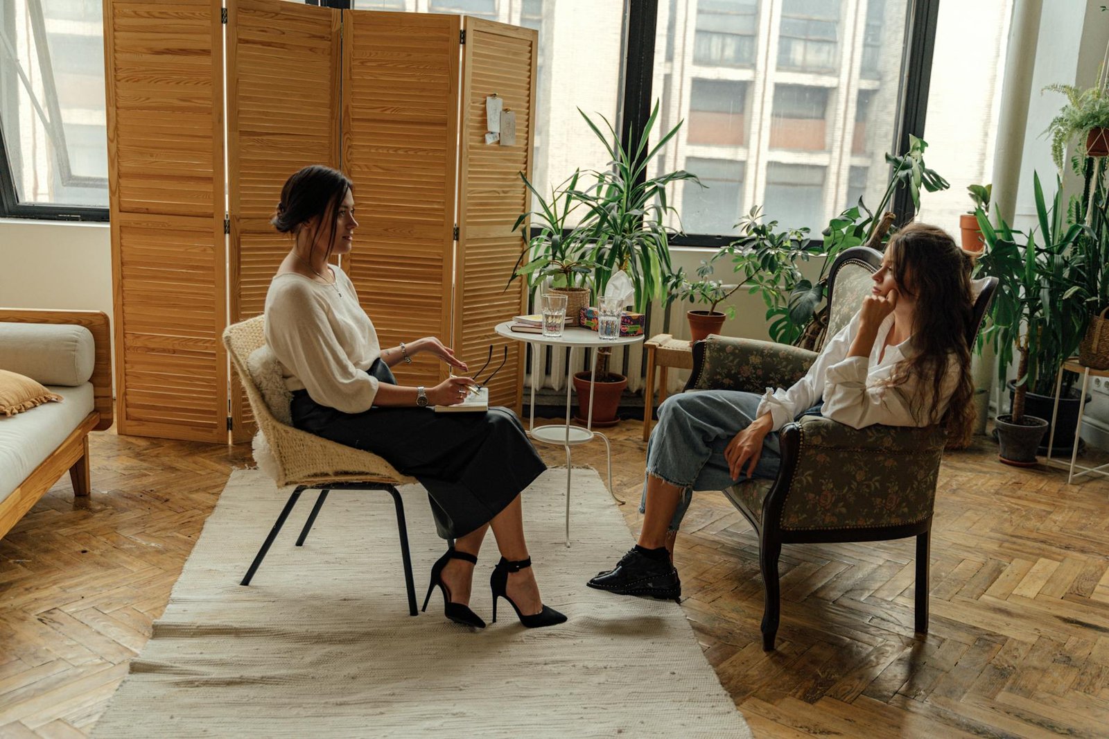 woman in white shirt sitting on chair